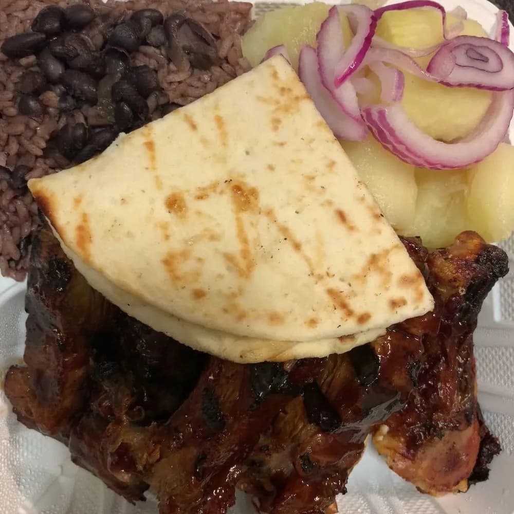 BBQ ribs with rice and black beans, yuca and pita