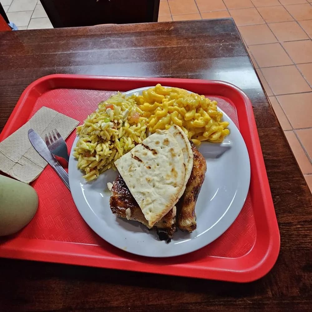 Charcoal chicken with mac and cheese, orzo salad and pita